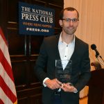 Shane Bauer holding the Anthony Shadid Award for Journalism Ethics at the 2017 award ceremony at the National Press Club in Washington, DC.